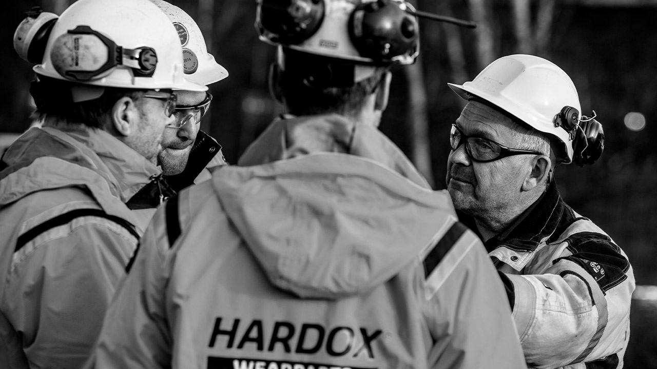 A group of workers in hard hats from a Hardox® Wearparts Center.
