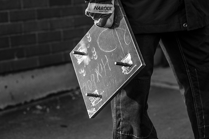 Someone carrying a sample of Hardox® wear plate.