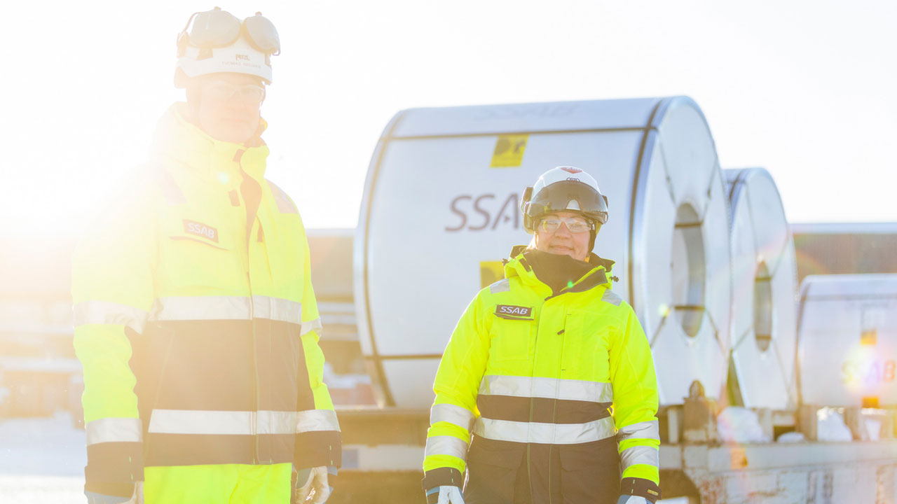 ssab workers in front of steel coils