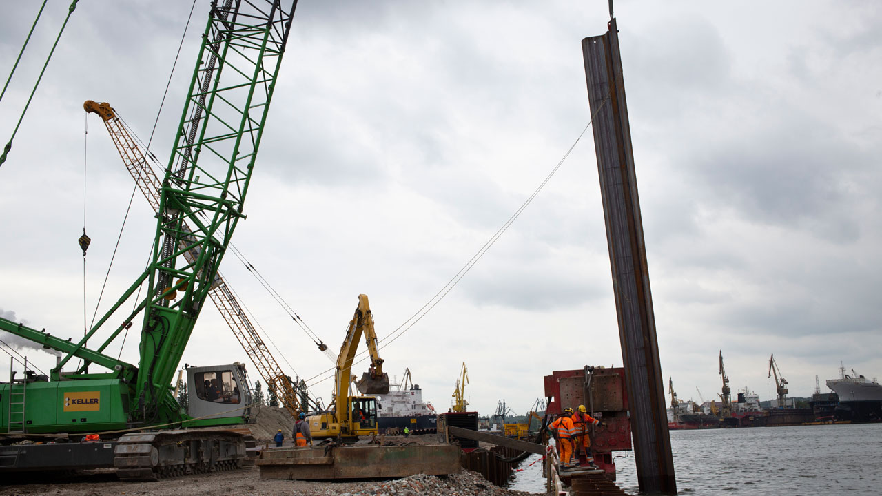 Huge steel pile on the waterline of the future harbor wharf in Gdańsk, Poland