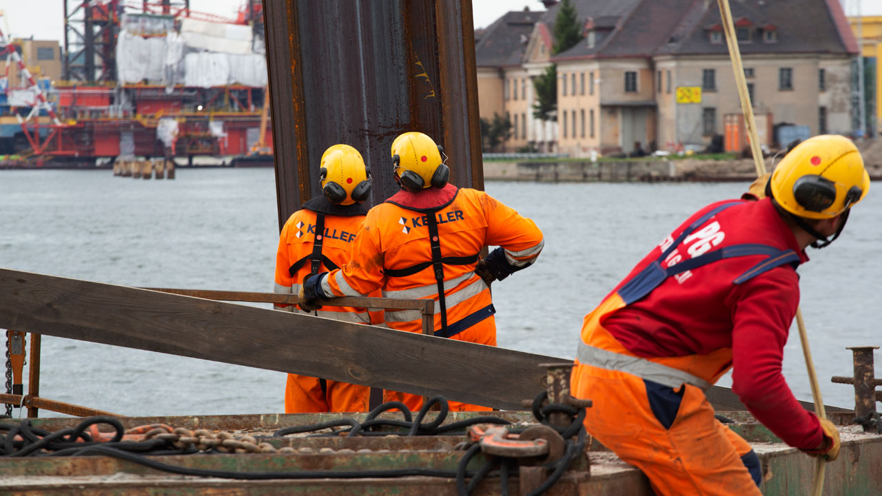 Huge steel pile on the waterline of the future harbor wharf in Gdańsk, Poland