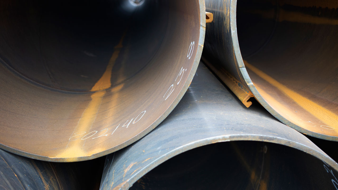 Huge steel pile on the waterline of the future harbor wharf in Gdańsk, Poland