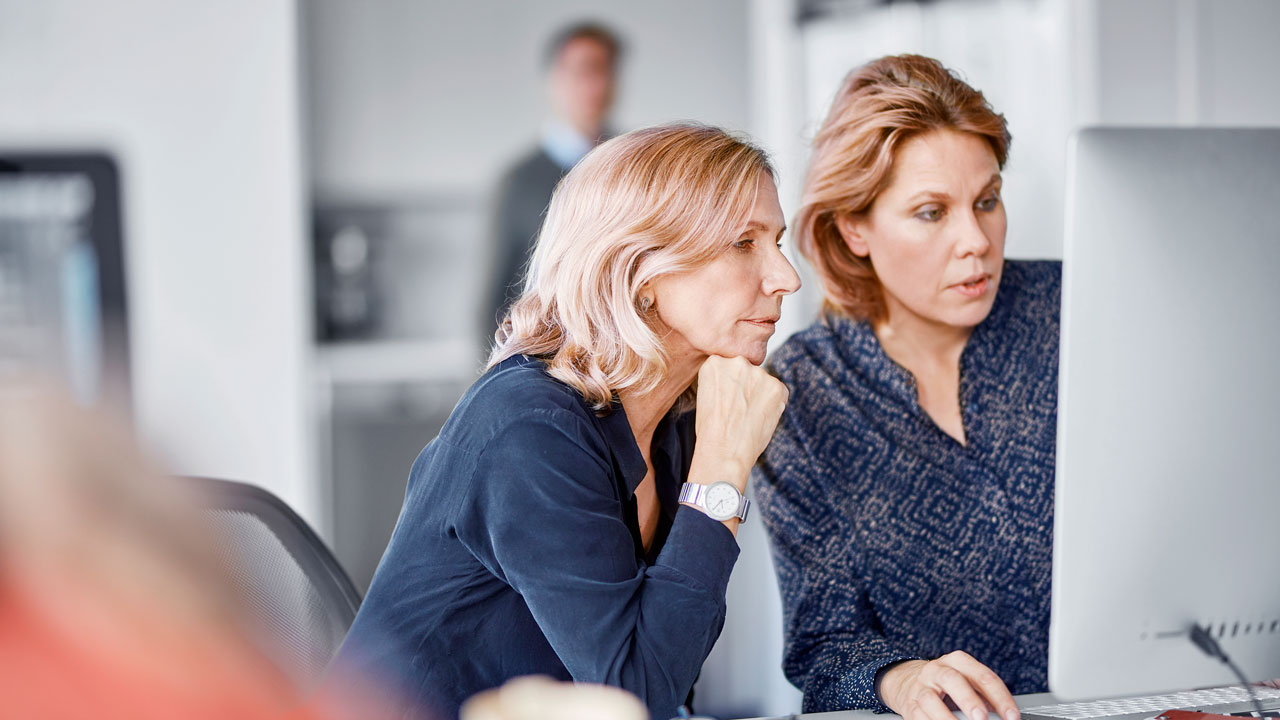 Two women looking at a screen