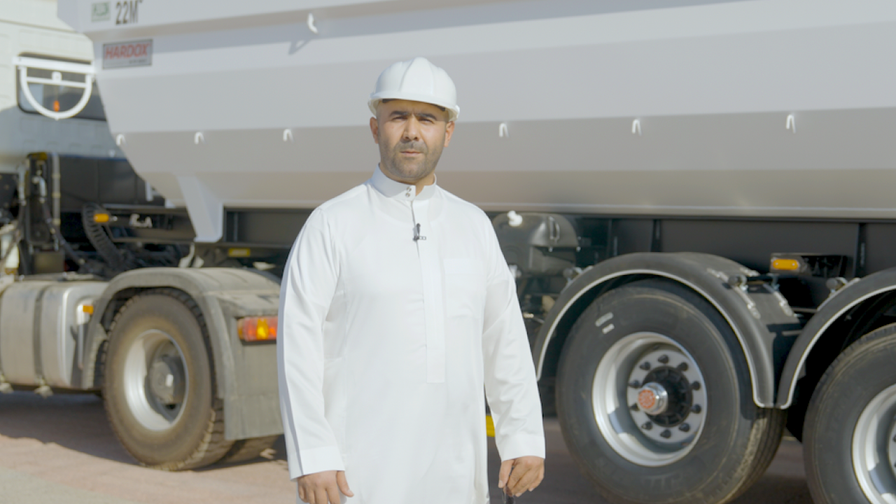 Tipper and dump body producer Ali Al Jeathen standing in front of a trailer with body made in Hardox 500 Tuf high strength steel.