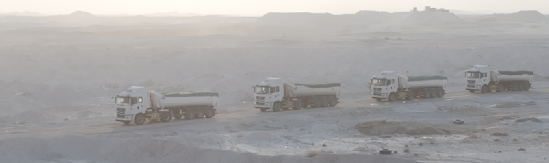 Three trucks by Al Jeathen driving in the desert with tipper bodies made in Hardox 500 Tuf.