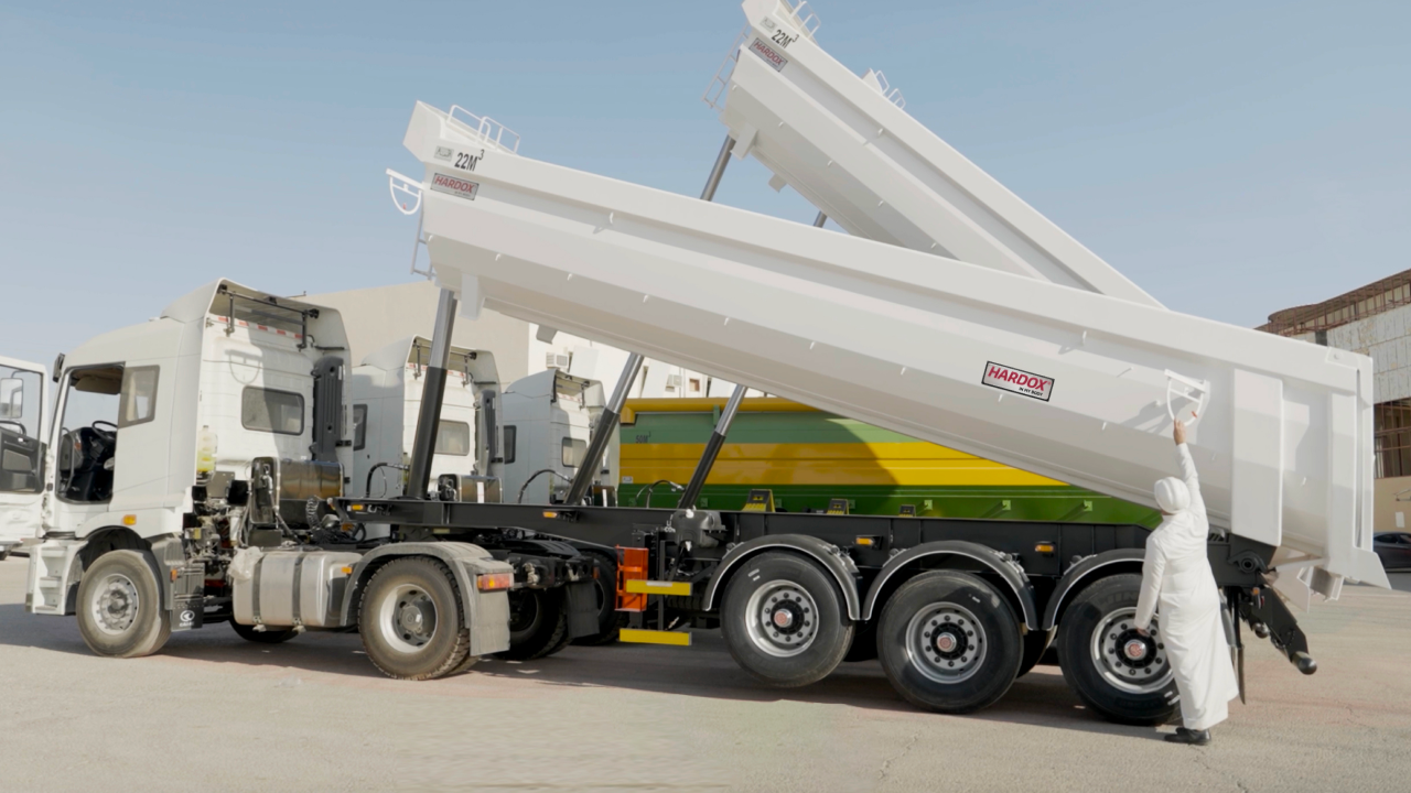 Two white dump trailers with the Hardox In My Body sign of quality and trust on the bodies.