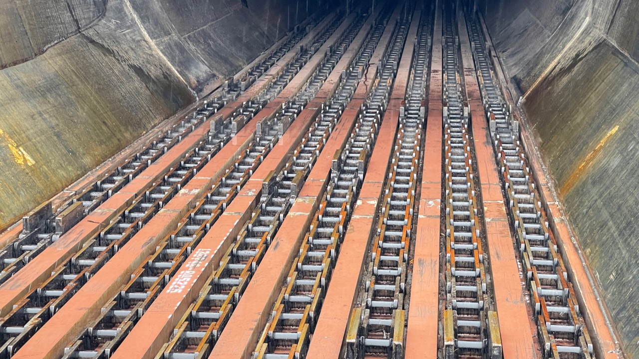 A log conveyor with chain guides and plates made in corrosion resistant Hardox® HiAce steel.
