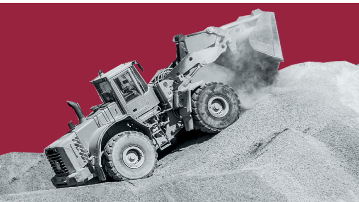 A wheel loader in a quarry shown on a red background