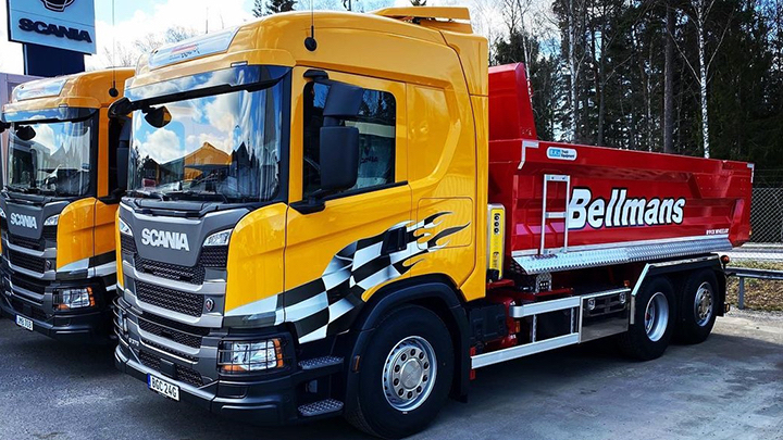 Bright yellow and fiery red dump truck built with Hardox® 500 Tuf grabbing attention.