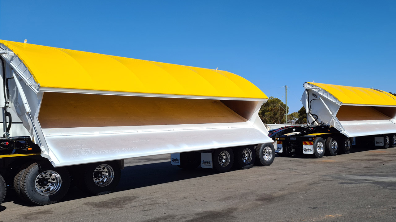 Enormous side dump trailer with yellow covers