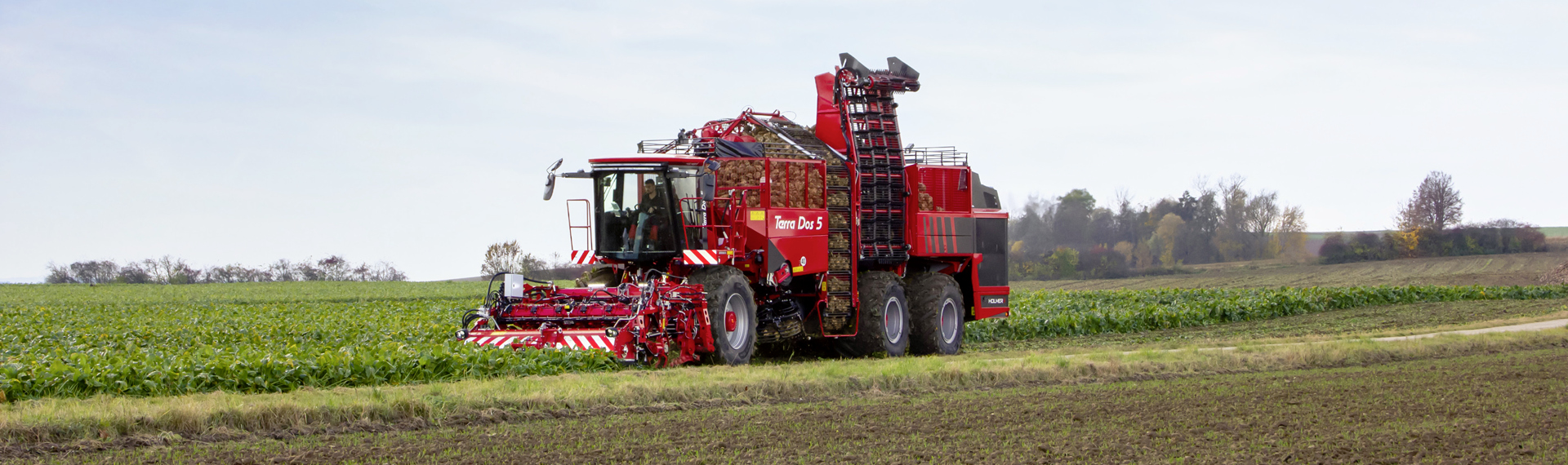 Sugar beet harvester made in Strenx high-strength structural steel working the fields.