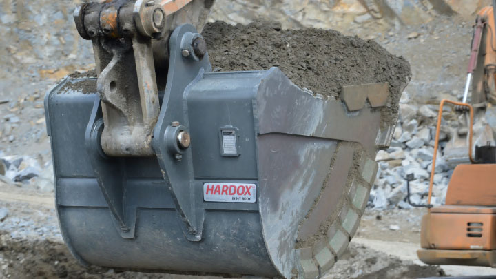 A huge mining bucket loaded with abrasive debris, made in Hardox® wear plate