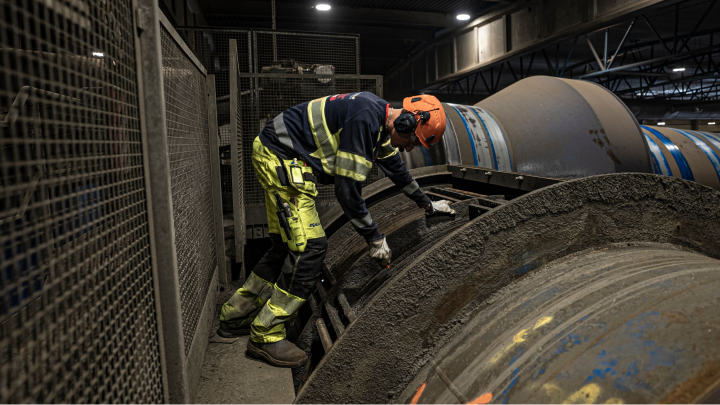 Mies vaihtamassa Stena Recyclingin kierrätysrumpujen ristikkosegmenttejä. 