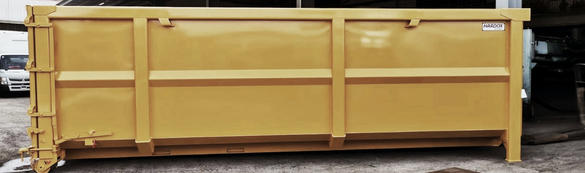 由 Hardox® HiAce 钢材制成的黄色钢制回收集装箱。