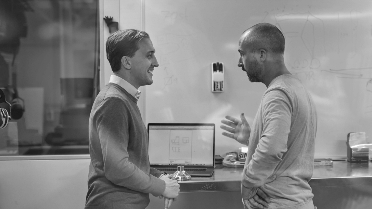 Dva pracovníci technické podpory SSAB diskutují o optimalizaci otěruvzdorné oceli Hardox® 500 Tuf v rypadlové lžíci.