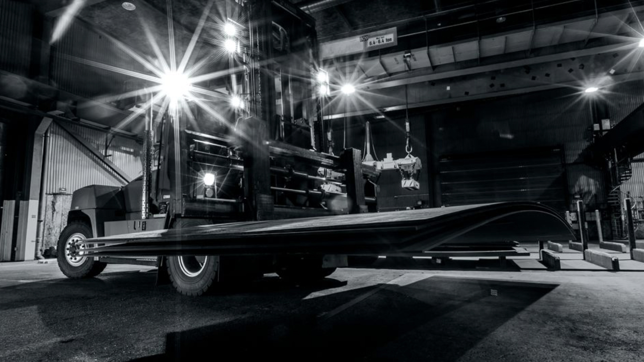 Wear plates of Hardox® 450 steel being delivered to a workshop for fabrication. Black and white image.