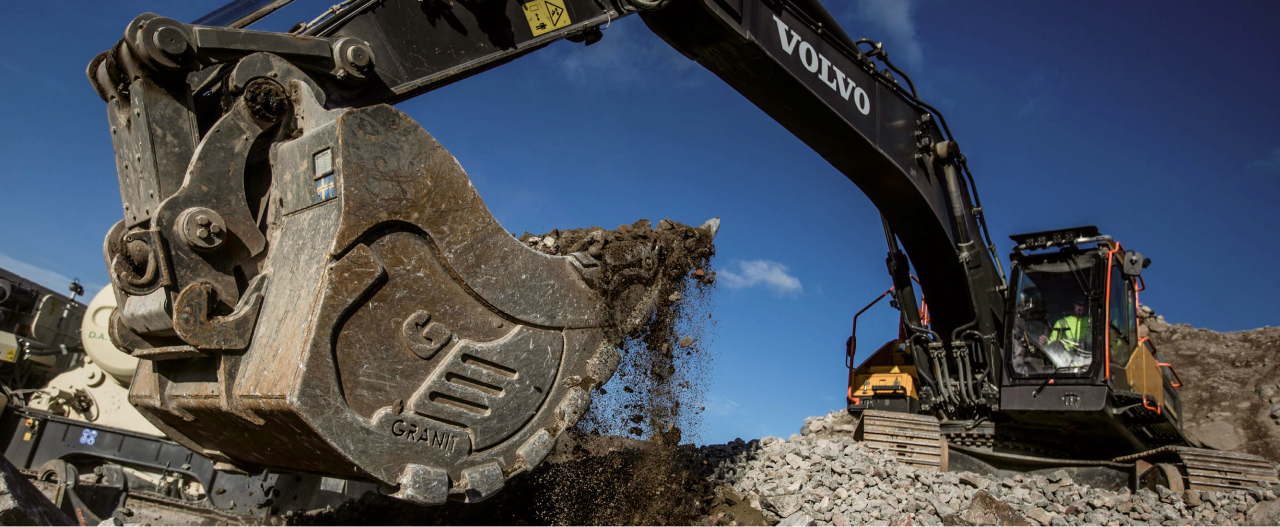 Una excavadora de Volvo en una obra con una cuchara fabricada con el acero Hardox® 500 Tuf extra duro de alta resistencia.