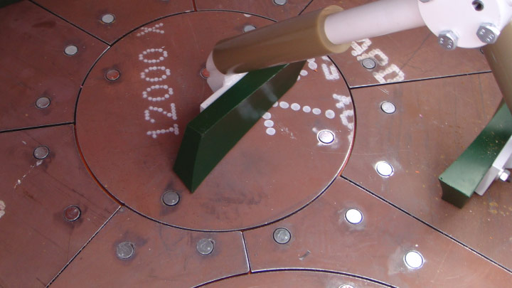 A huge round metal plate of Hardox 600 steel used in the floor lining of a planetary mixer.
