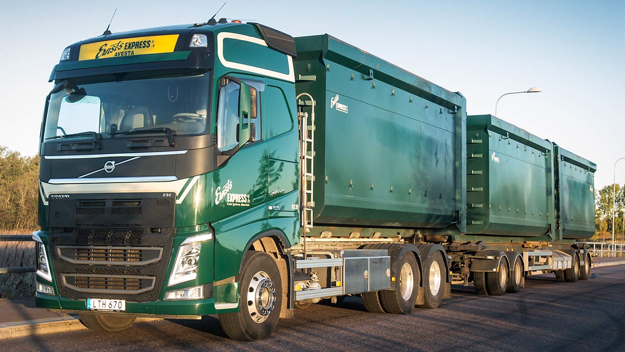 Green truck with containers.