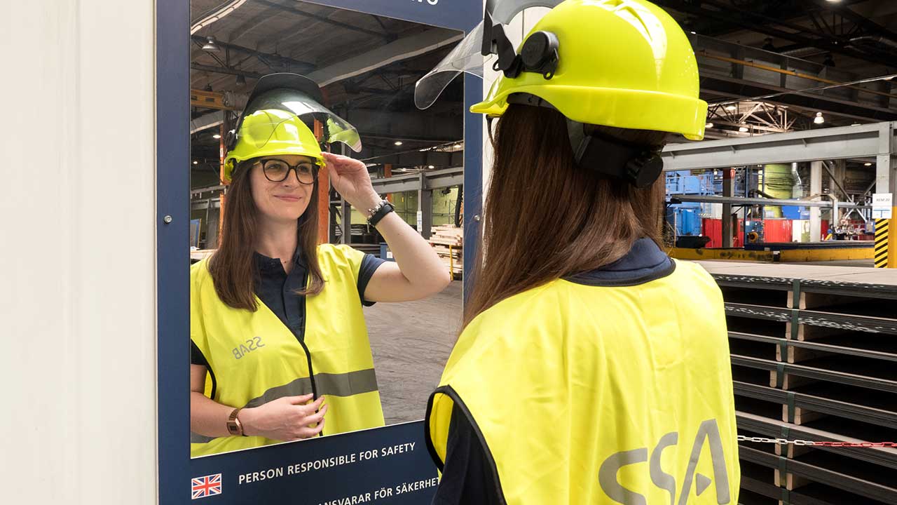 Woman checking safety equipment in mirror