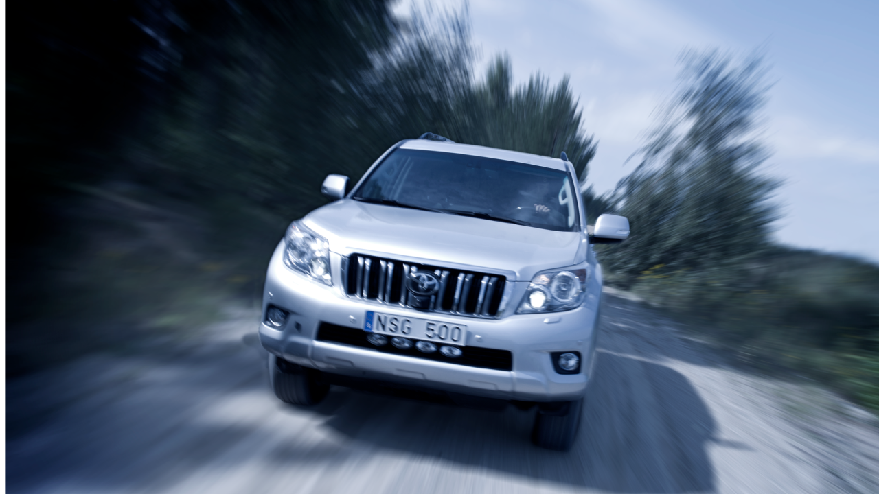 A view from the front of an armored SUV driving on the road