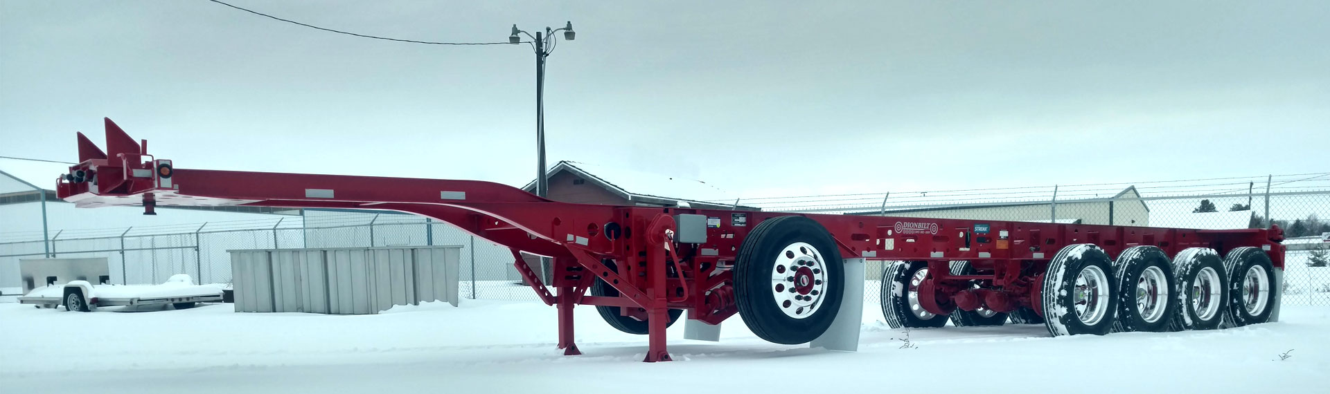 A long lightweight trailer chassis made with Strenx® 100 standing on snowy ground