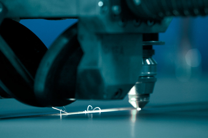Tête de découpe laser en train de couper une plaque d’acier Strenx.