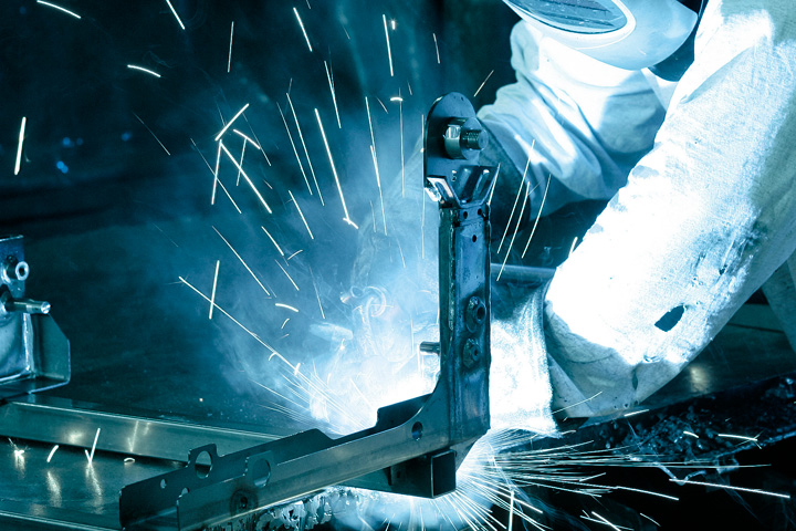 En operatör svetsar höghållfast Strenx® stål i verkstaden.